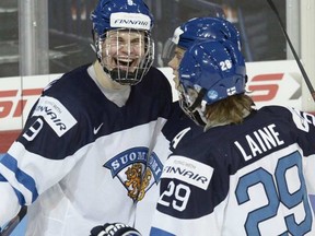 Jesse Puljujarvi looks like a young Jaromir Jagr as he celebrates a goal with linemates Sebastian Aho (hidden) and Patrik Laine in the third period of Finland's gold medal win over Russia.