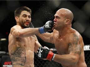 Robbie Lawler, right, trades blows with Carlos Condit during a welterweight championship mixed martial arts bout at UFC 195, Saturday, Jan. 2, 2016, in Las Vegas.