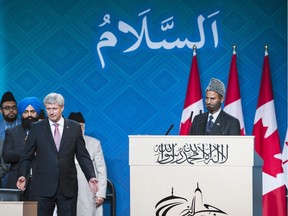 Then prime minister Stephen Harper is thanked by Ahmadiyya Muslim Jama'at National president Lal Khan Malik, right, after speaking at the Jalsa Salana Canada annual convention in Toronto on Wednesday, August 28, 2015.