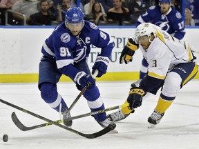 Tampa Bay Lightning centere Steven Stamkos loses the puck to former Nashville Predators defenceman Seth Jones during an NHL pre-season hockey game on Sept. 22, 2015, in Tampa, Fla.