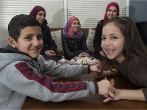 An extended family of Syrian refugees will get a chance to watch the Oilers from a luxury box at Rexall Place on Saturday, Jan. 23. The family includes (front row, from left) Talal, 7, and Layan, 6, as well as (back row, from left) Heba; Maya, 13; and Tahani. The family is reluctant to give their last names, fearing reprisals against relatives in Syria.