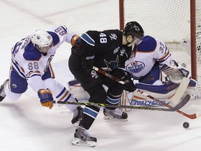 Sharks centre Tomas Hertl shoots against Edmonton Oilers defenceman Brandon Davidson and goalie Cam Talbot during NHL action in San Jose on Thursday, Jan. 14, 2016.