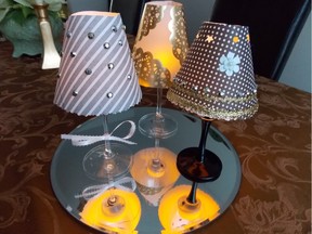 Wineglass lampshades grouped on a mirror. (The two in front were made by the writer's seven-year-old grandson.)