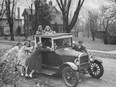 1950s teens push a 1920s jalopy.
