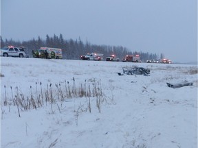 A vehicle lies in the centre ditch beside Highway 63 following a single-car crash that killed a 51-year-old man on Thursday.