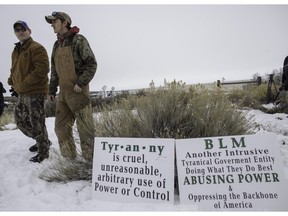 Members of an armed anti-government militia, monitor the entrance to the Malheur National Wildlife Refuge Headquarters near Burns, Oregon this week.  The occupation of a wildlife refuge by armed protesters in Oregon reflects a decades-old dispute over land rights in the United States, where local communities have increasingly sought to take back federal land.