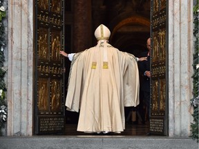 Pope Francis opens a door at St Peter's Basilica to mark the start of the Jubilee Year of Mercy.