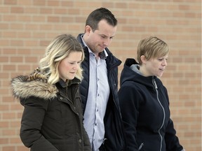 Jeff McClements, son of Diane McClements, centre, and other family members leave the Wetaskiwin courthouse.