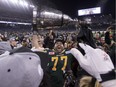 Edmonton Eskimos Mathieu Boulay (77) hoists the cup over his head after defeating the Ottawa Redblacks at the 103rd Grey Cup on November 29, 2015 in Winnipeg