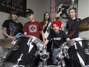 Members of Control Angel, left to right: Nathan Jeynes, Erick Seed, Mylia Johnson - Archambault, Malcolm Blankenship, and Jakob Shapiro pose for a photo during a band practice at Backbeat.