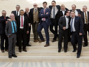 Edmonton city council members goof around as they pose for the official photo following the swearing-in of Ward 12 Coun. Mohinder Singh Banga at City Hall in Edmonton on Feb. 26, 2016.
