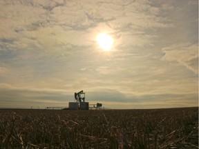 An oil pump jack works on a farm east of Arrowwood Alberta on Feb. 11, 2016.