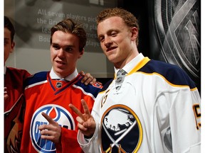 Connor McDavid and Jack Eichel pose in their team jerseys at the 2015 NHl Entry Draft last June in Sunrise, Fla.