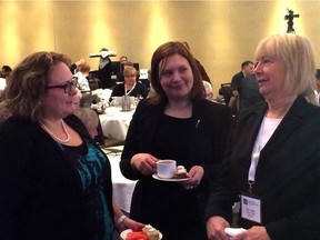Alberta Health Minister Sarah Hoffman, left, speaks with associate health minister Brandy Payne and Alberta Health Services board chair woman Linda Hughes on Monday, Feb. 8, 2016, at the Westin Hotel during a conference on physician pay.