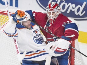 Edmonton Oilers forward Benoit Pouliot collides with Montreal Canadiens goaltender Ben Scrivens during NHL action in Montreal on Feb. 16, 2016.