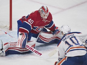 Montreal Canadiens goalie Ben Scrivens makes a save on Edmonton Oilers forward Nail Yakupov during NHL action in Montreal on Feb. 6, 2016.
