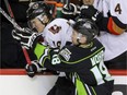 Dawson Martin of the Calgary Hitmen is hit by Edmonton Oil Kings' Kobe Mohr in WHL action in Calgary on January 16, 2016.