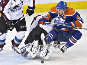 Edmonton Oilers' Taylor Hall collides with Colorado Avalanche goalie Calvin Pickard  during third-period NHL action on Saturday, Feb. 20, 2016.