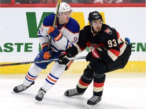 Connor McDavid, shown here battling Ottawa Senators' Mika Zibanejad during Thursday's game in Ottawa, will play his first NHL game in Montreal on Saturday.