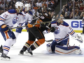 Anaheim Ducks' Corey Perry, center, goes after the puck past Edmonton Oilers goalie Cam Talbot, right, during the second period of an NHL hockey game Friday, Feb. 26, 2016, in Anaheim, Calif.