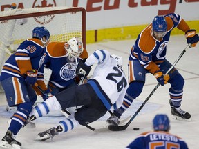 Eric Gryba (at right) offers a massive net-front presence to counter the likes of big forwards like Winnipeg's Blake Wheeler.