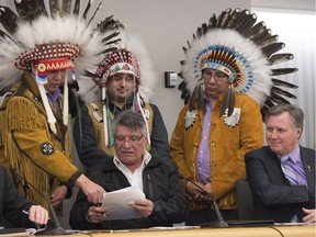 Chief Aurthur Noskey of Loon River points at the agreement that Grand Chief Robert Grey is about to sign. Behind him is Chief Isaac Labouran-Avirom and Chief James Alook with Minister of Indigenous Relations Richard Feehan. The Kee Tas Kee Now agreement outlines the framework for establishing a First Nations education authority.