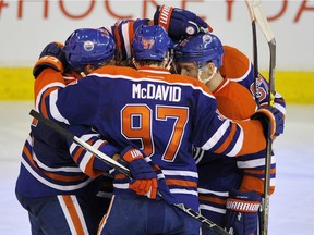 Edmonton Oilers' Connor McDavid hugs his teammates following a power play goal against the Columbus Blue Jackets during NHL action at Rexall Place in Edmonton February 2, 2016.