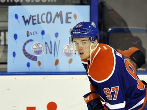 Edmonton Oilers' Connor McDavid skates by a sign prior to his NHL game against the Columbus Blue Jackets' at Rexall Place in Edmonton February 2, 2016.