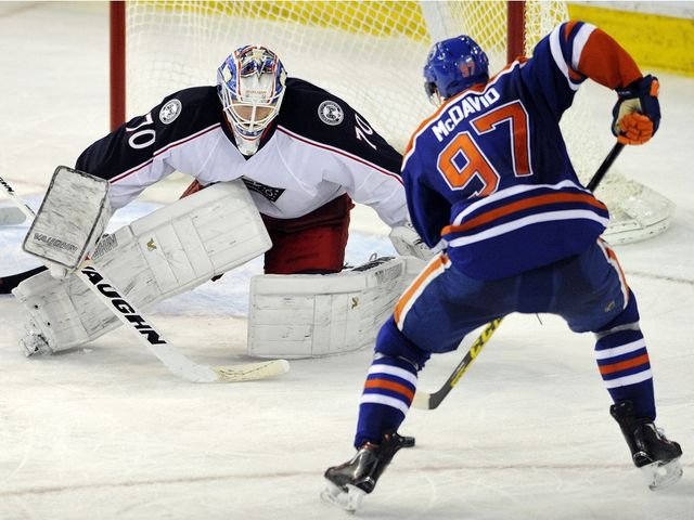 EDMONTON, AB.; FEBRUARY 2, 2016 -- Edmonton Oilers' Connor McDavid (R) goes around Columbus Blue Jackets' goalie Joonas Korpisalo during NHL action at Rexall Place in Edmonton February 2, 2016. (Dan Riedlhuber/Postmedia News) For n/a (Postmedia News) OILERS-BLUE JACKETS ORG XMIT: Oilers-Blu