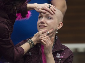 Kyrsti MacDonald, who was the first to have her head shaved, is embraced by her mom Tammy MacDonald during the 14th annual Hair Massacure where about 2000 participants  shave their head at  West Edmonton Mall in support of children with life-threatening medical conditions and/or donating their hair to create wigs for children experiencing hair loss.