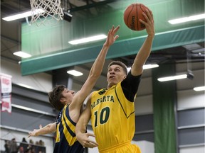 University of Alberta Golden Bears Brody Clarke shoot over Trinity Western University Spartans' Patrick Vandervelden on Feb. 5 at the Saville Community Sports Centre.