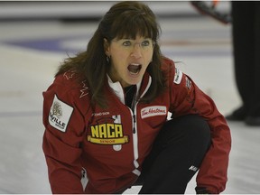Skip Cathy King yells to her sweepers during game action against the Deb Santos foursome at the Alberta Senior Curling Championship finals held at the Granite Curling Club in Edmonton on February 17, 2013.