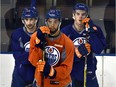 Edmonton Oilers Connor McDavid (right) listens during practice on Feb. 1, 2016 as he gets set to return to his first NHL game after being injured. Teammates Jordan Eberle (14) and Darnell Nurse (25) stand beside him at Rexall Place.