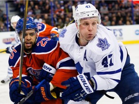 Darnell Nurse (25) of the Edmonton Oilers battles Leo Komarov (47) of the Toronto Maple Leafs during second period action at Rexall Place in Edmonton, Alta. on Feb. 11, 2016.