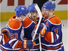 Edmonton Oilers Jordan Eberle celebrates his open net goal with Ryan Nugent- Hopkins and taylor Hall against the Colorado Avalanche during third period NHL action at Rexall Place on February 16, 2013 in Edmonton.