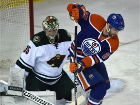 Edmonton Oilers Benoit Pouliot (67) tries to deflect the puck on Minnesota Wild goalie Darcy Kuemper (35) during NHL action at Rexall Place in Edmonton, February 18, 2016.