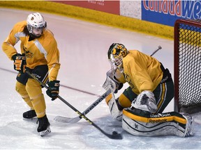 EDMONTON, ALTA: FEBRUARY 25, 2016 -- University of Alberta Golden Bears Levko Koper (40) fires a shot at goalie Luke Siemens (30) at practice as they prepare for the western semis that start Friday at Clare Drake in Edmonton, February 25, 2016. (ED KAISER/PHOTOGRAPHER)