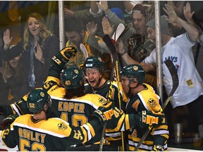 The University of Alberta Golden Bears celebrate Jordan Hickmott's winning goal in a sweep over the Mount Royal Cougars in Game 2 of the Canada West semifinals at Clare Drake Arena on Saturday. (Ed Kaiser)