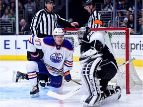 Connor McDavid #97 of the Edmonton Oilers reacts after a stop in play as he is puhed into the net and Jonathan Quick #32 of the Los Angeles Kings during the first period at Staples Center on February 25, 2016 in Los Angeles, California.