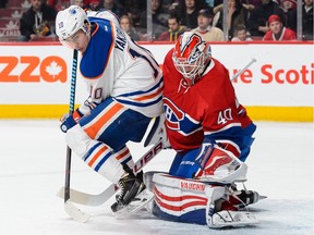 Edmonton Oilers forward Nail Yakupov screens Montreal Canadiens goalie ben Scrivens as Scrivens gets his glove on the puck during NHL action at Montreal's Bell centre on Feb. 6, 2016.