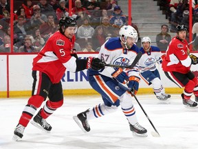 Cody Ceci (5) of the Ottawa Senators defends against Benoit Pouliot (67) of the Edmonton Oilers at Canadian Tire Centre on Feb. 14, 2015 in Ottawa, Ont. The Oilers and the Senators face each other again on Thursday, Feb. 4, 2016.