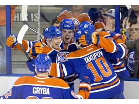 Edmonton Oilers' Eric Gryba (62), Andrew Ference (21), Connor McDavid (97), Nail Yakupov (10) and Benoit Pouliot (67) celebrate a goal by McDavid against the Detroit Red Wings during second period NHL action in Edmonton, Alta., on Wednesday October 21, 2015.