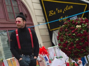 Jesse Hughes of Eagles of Death Metal pays tribute to the victims of the Paris terrorist attacks at a makeshift memorial in front of the Bataclan concert hall.