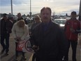 George Clark, with his supporters behind him, explains his plan to take over the New Democratic Party in a Calgary Walmart parking lot on Friday, Feb. 19, 2016.