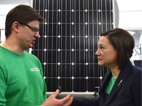 Shannon Phillips, Alberta Minister of Environment and Parks speaks with Mikhail Ivanchikov of Dandelion Renewables after announcing renewable solar energy funding as part of its actions under the Climate Leadership Plan at the NAIT Centre for Sustainable Energy Technologies in Edmonton.