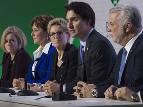 Canadian Prime Minister Justin Trudeau speaks during a news conference with Albeta Premier Rachel Notley (left), B.C. Premier Christy Clark , Ontario Premier Kathleen Wynne , Quebec Premier Philippe Couillard and Saskatchewan Premier Brad Wall at the United Nations climate change summit Monday, November 30, 2015 in Le Bourget, France.