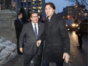 Montreal Mayor Denis Coderre, left, greets Prime Minister Justin Trudeau at Montreal city hall on Jan. 26, 2016.  They discussed, among other things, the mayor's opposition to the proposed Energy East pipeline.