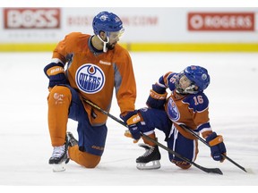Make-A-Wish recipient Kohen Flett, 8, talks with Darnell Nurse during practice on Wednesday at Rexall Place.