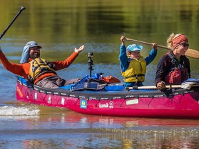 Benoit Gendreau-Berthiaume, left, and Magali Moffatt, right, and their five year-old son Mali arrive in Montreal after their 5,000-km  canoe trip from Edmonton.