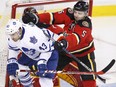 Toronto Maple Leafs' Nazem Kadri, left is pushed away from the Calgary net by Calgary Flames' Mark Giordano during second period NHL action in Calgary, Alta., Tuesday Feb. 9, 2016.